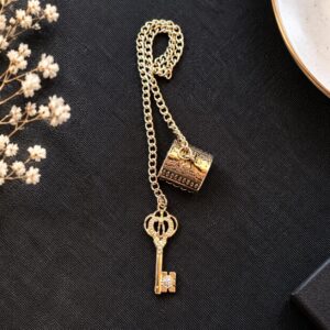 Apagavela Llave decorativo con acabado dorado